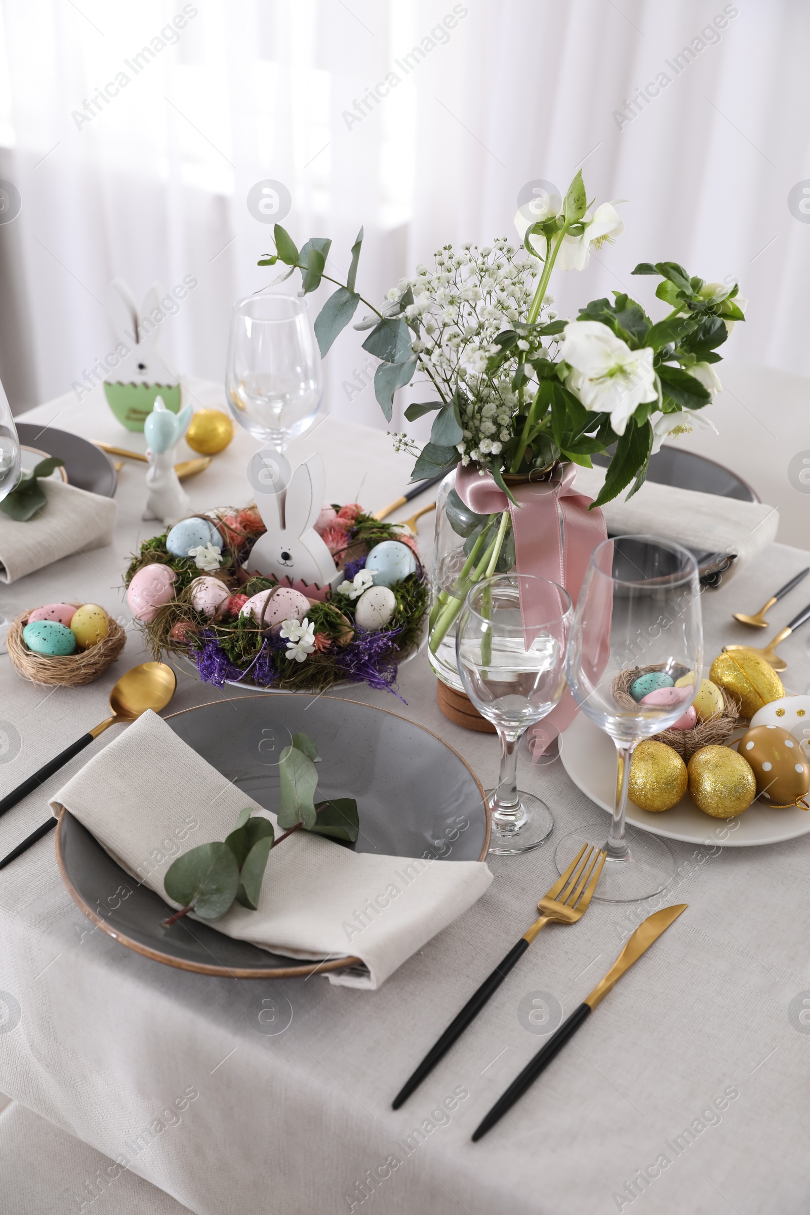 Photo of Beautiful Easter table setting with festive decor indoors