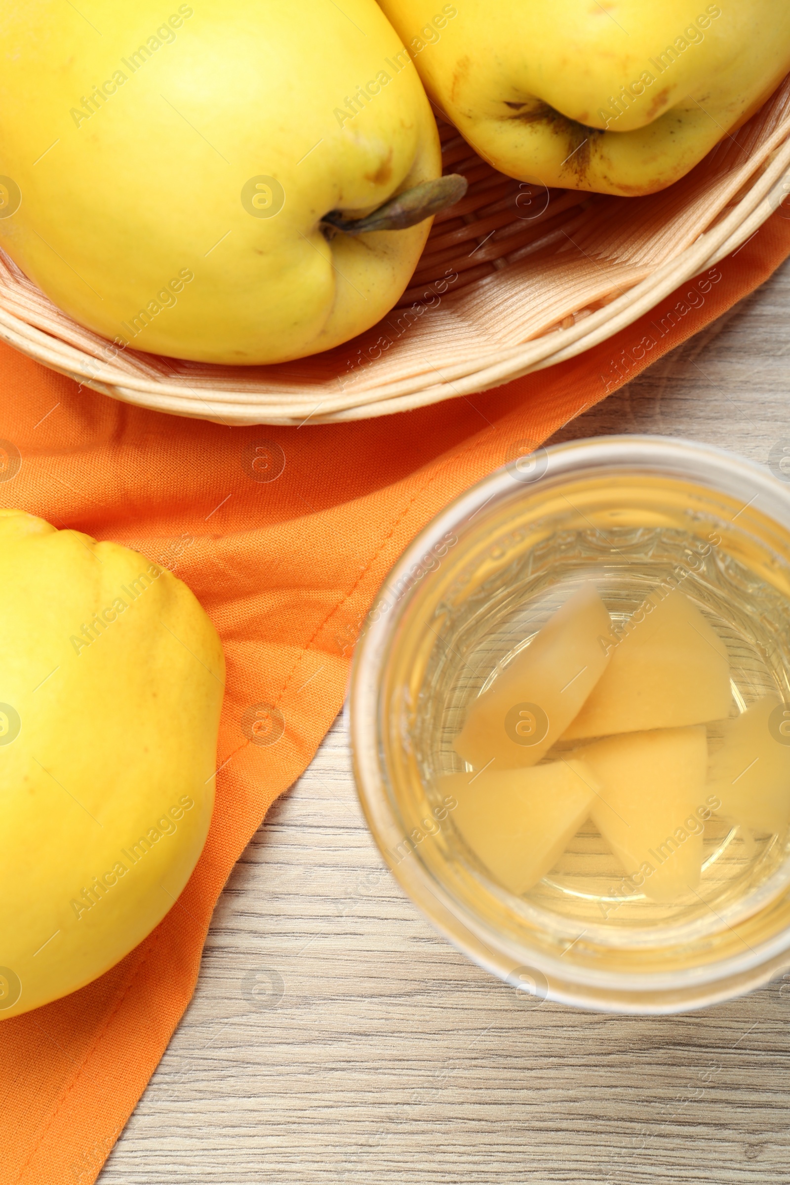 Photo of Delicious quince drink in glass and fresh fruits on wooden table, top view