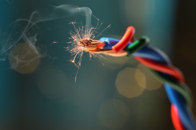 Image of Sparking wiring on blurred background, closeup view