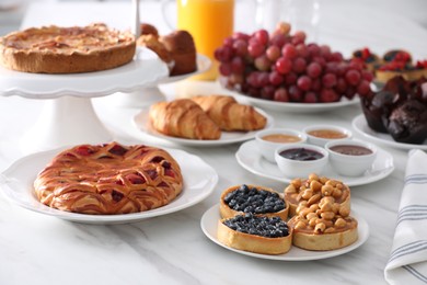 Variety of snacks on white marble table in buffet style