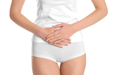 Young woman holding hands near underwear on white background. Gynecology