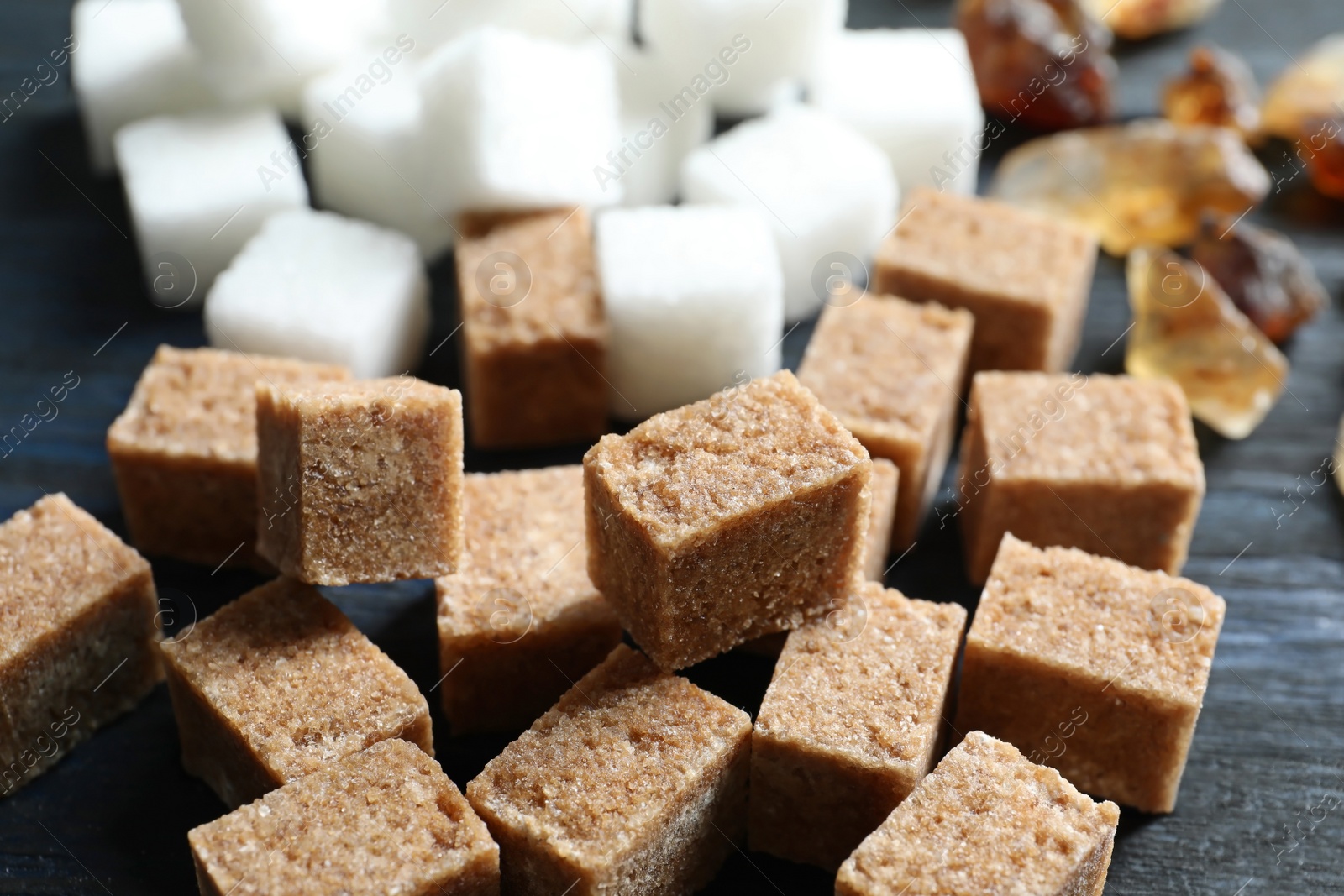 Photo of Brown sugar on wooden background, closeup