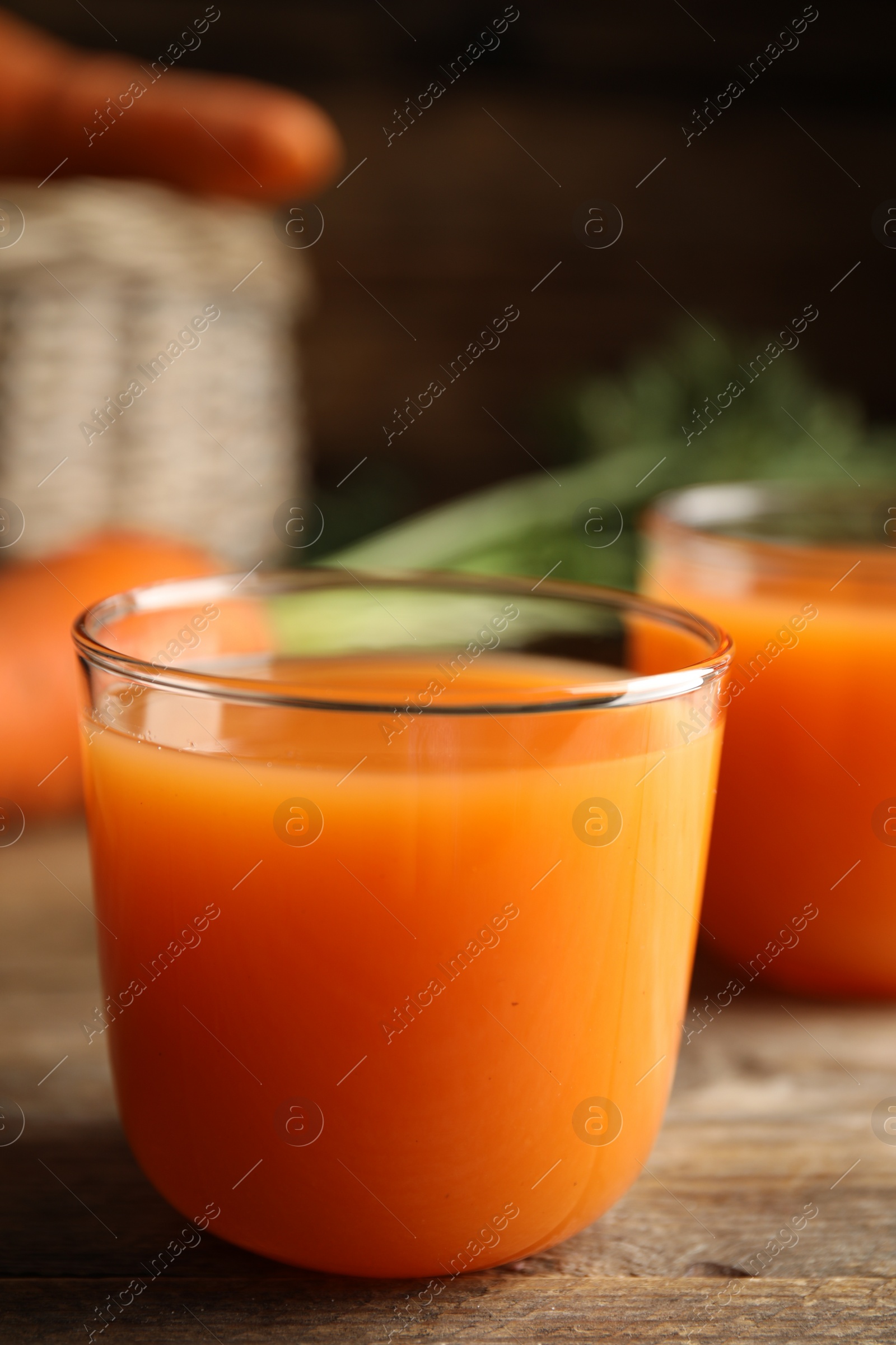 Photo of Freshly made carrot juice on wooden table