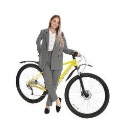 Young businesswoman with bicycle on white background