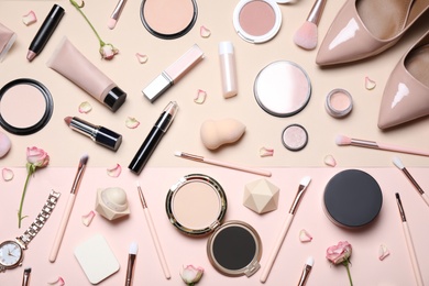 Photo of Set of luxury makeup products and elegant shoes on beige background, flat lay