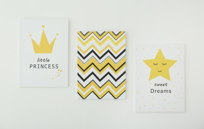 Photo of Different cute pictures on white wall. Children's room interior elements