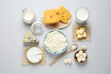 Different dairy products on light background, flat lay