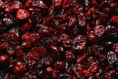 Photo of Tasty cranberries as background, top view. Dried fruits as healthy snack