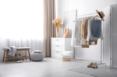 Photo of Dressing room interior with stylish white furniture