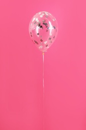 Photo of Bright balloon with sparkles on color background
