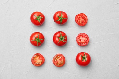 Photo of Flat lay composition with ripe tomatoes on light background
