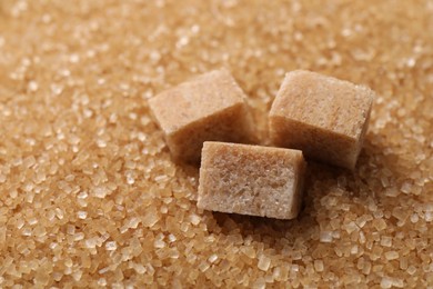 Photo of Different types of brown sugar as background, closeup. Space for text