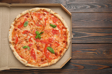 Photo of Delicious pizza Margherita on wooden table, top view. Space for text