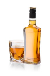 Photo of Glass and bottle of whiskey isolated on white