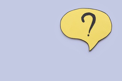 Photo of Paper speech bubble with question mark on light grey background, top view. Space for text