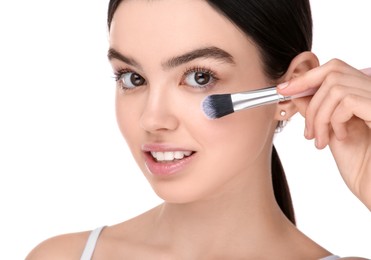 Photo of Teenage girl with makeup brush on white background