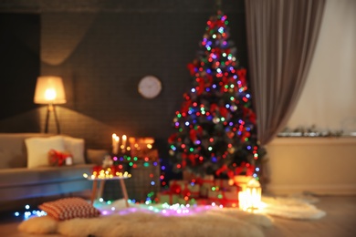 Photo of Blurred view of stylish room interior with decorated Christmas tree