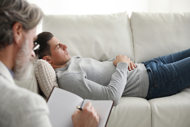 Photo of Psychotherapist and patient in office. Hypnotherapy session