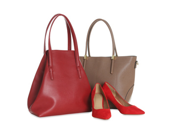 Photo of Different stylish woman's bags and shoes isolated on white