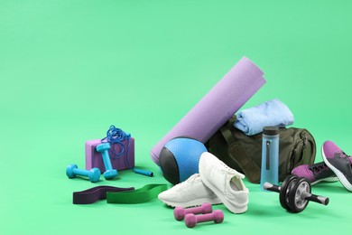 Photo of Many different sports equipment on green background, space for text
