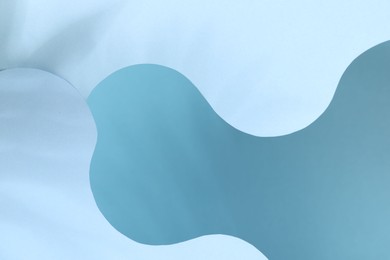 Photo of Presentation of product. Paper cutouts on light blue background. Space for text