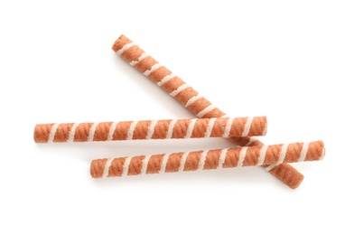 Photo of Tasty wafer roll sticks on white background, top view. Crispy food