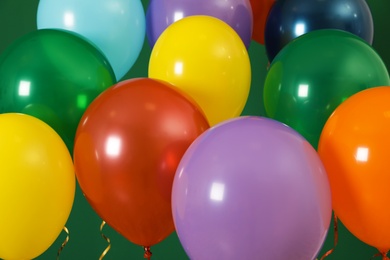 Photo of Bright balloons on color background. Celebration time