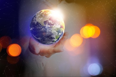 Image of World in our hands. Woman holding digital model of Earth, closeup view 