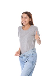 Photo of Slim woman in oversized jeans on white background. Weight loss