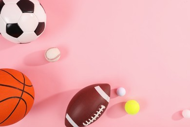 Many different sports balls on pink background, flat lay. Space for text