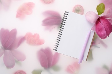 Photo of Guest list. Notebook, pen and magnolia on spring floral background, flat lay. Space for text