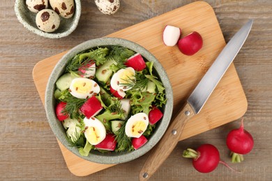 Photo of Delicious radish salad, ingredients and knife on wooden table, flat lay