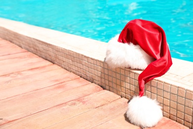Photo of Authentic Santa Claus hat near pool at resort