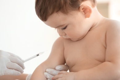 Photo of Doctor vaccinating baby in clinic