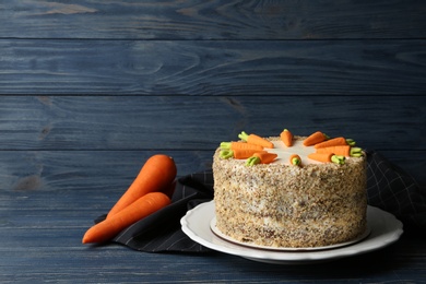 Photo of Composition with delicious carrot cake on blue wooden background, space for text