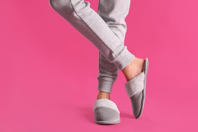 Photo of Woman in fluffy slippers on pink background, closeup