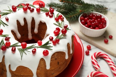 Photo of Composition with traditional homemade Christmas cake on white marble table, closeup