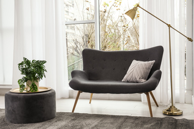 Photo of Modern comfortable sofa in stylish home interior