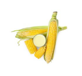 Photo of Tasty fresh corn milk in glass and cobs on white background, top view