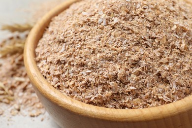 Photo of Dry wheat bran in bowl, closeup view