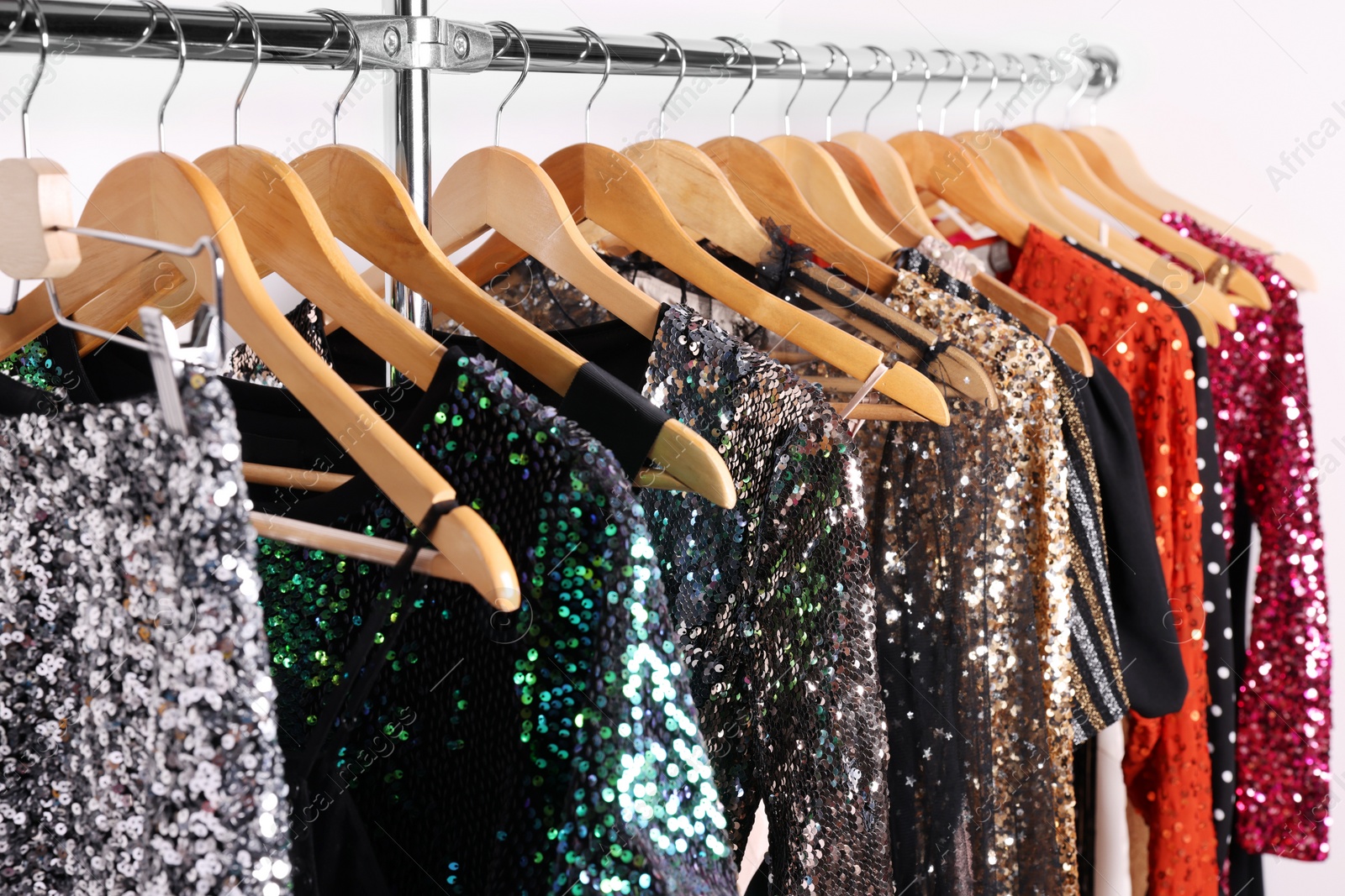 Collection of different beautiful women's party dresses on hangers in showroom. Stylish trendy clothes for high school prom Photo of Collection of different beautiful women's party dresses on hangers in showroom. Stylish trendy clothes for high school prom