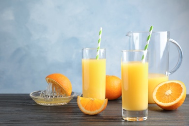 Photo of Composition with orange juice and fresh fruit on table. Space for text