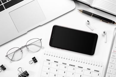 Photo of Composition with smartphone and laptop on white background, top view