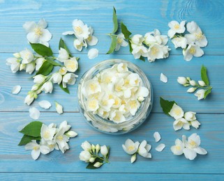 Photo of Flat lay composition with beautiful jasmine flowers on light blue wooden background