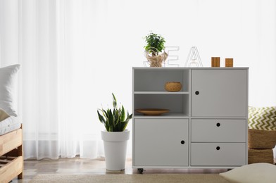 Photo of Chest of drawers in stylish room interior