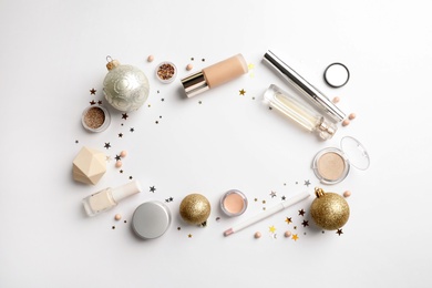 Photo of Flat lay composition with makeup products and Christmas decor on white background. Space for text