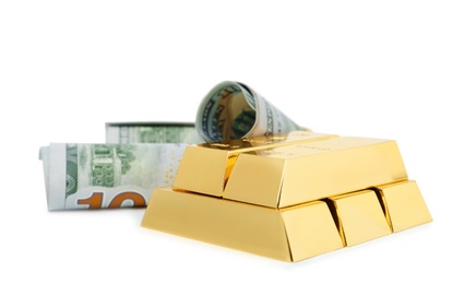 Photo of Shiny gold bars and dollar bills on white background