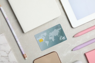 Photo of Flat lay composition with credit card and stationery on light grey marble background