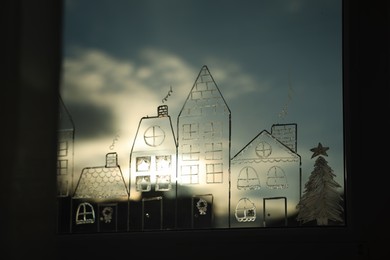 Photo of Beautiful drawing made with artificial snow on window. Christmas decor