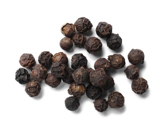 Photo of Aromatic spice. Many black dry peppercorns isolated on white, top view